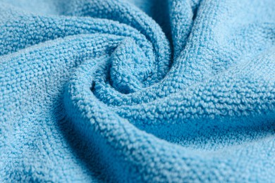 Photo of Soft crumpled blue towel as background, closeup