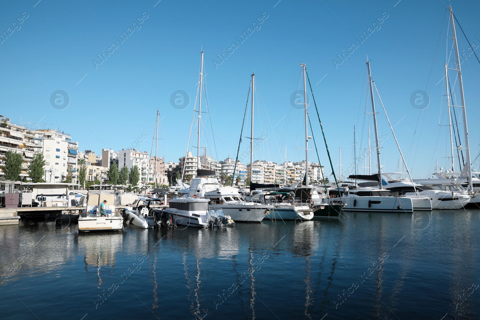 Photo of Picturesque view of port with modern boats on sunny day