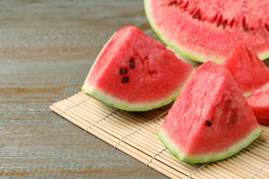 Photo of Slices of tasty ripe watermelon on wooden table, closeup. Space for text