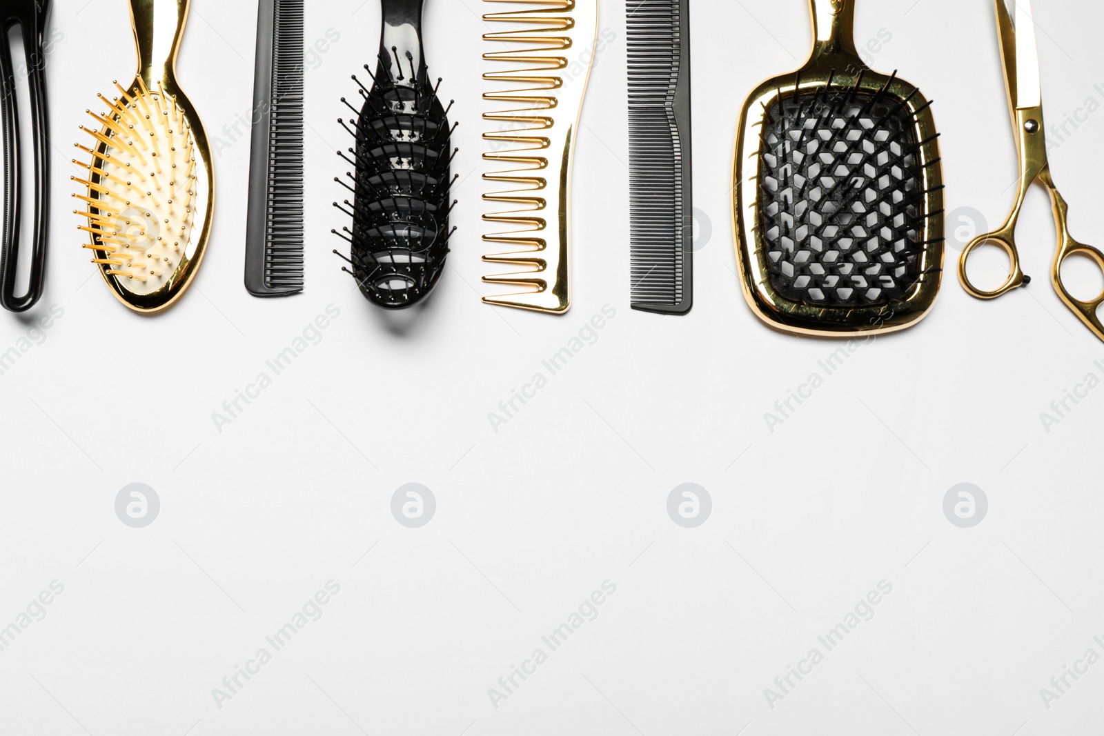 Photo of Hairdressing tools on white background, flat lay. Space for text