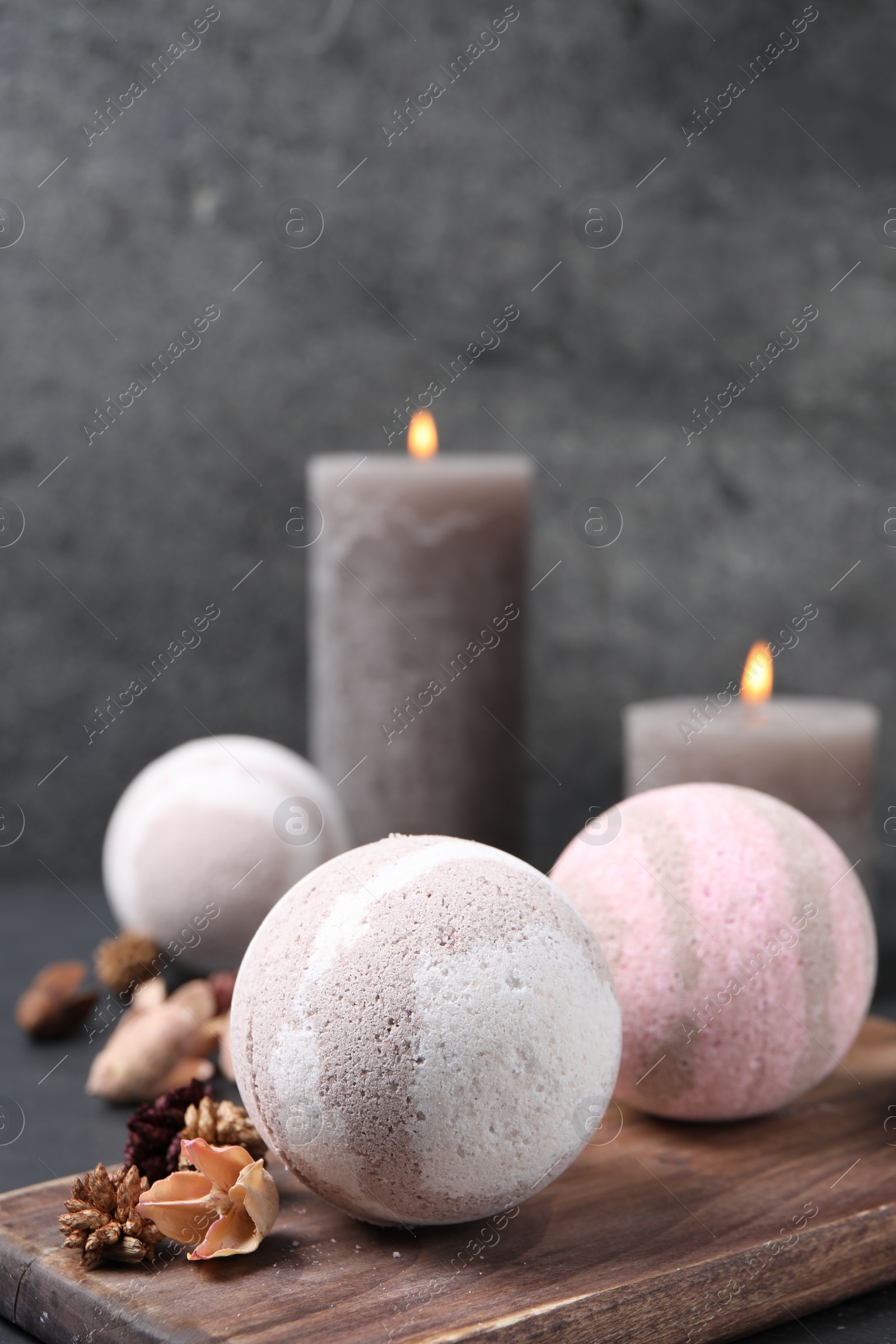 Photo of Bath bombs and dry flowers on table, closeup. Space for text