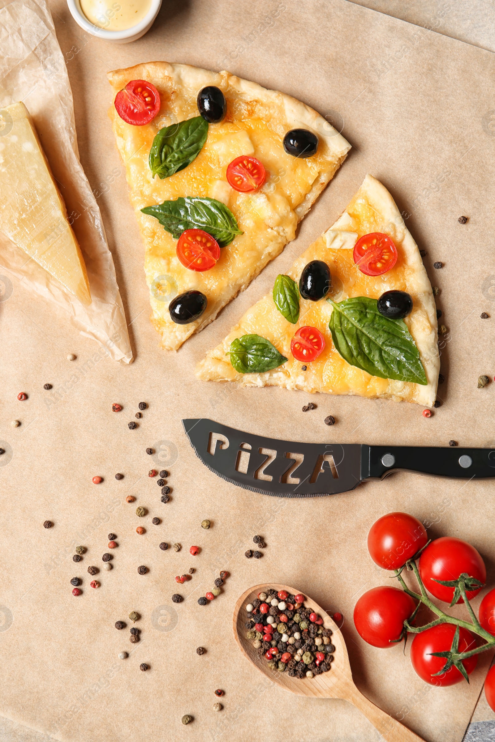 Photo of Flat lay composition with slices of tasty homemade pizza on parchment paper