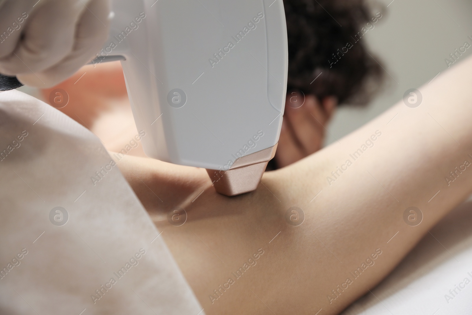 Photo of Woman undergoing laser epilation procedure, closeup view