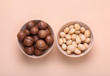 Photo of Delicious organic Macadamia nuts on beige background, flat lay