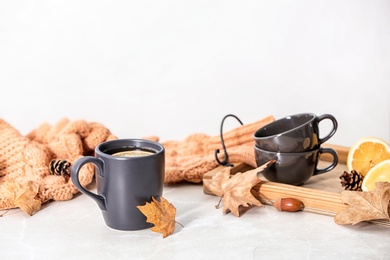 Composition with hot cozy drink and autumn leaves on table