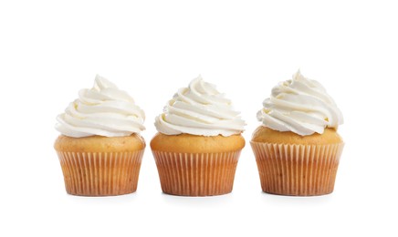 Delicious cupcakes decorated with cream on white background