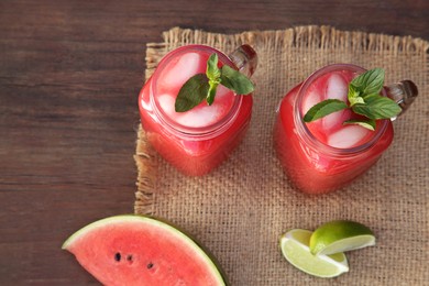 Photo of Delicious watermelon drink and fresh fruits on wooden table, above view