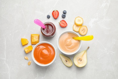 Healthy baby food and ingredients on grey table, flat lay