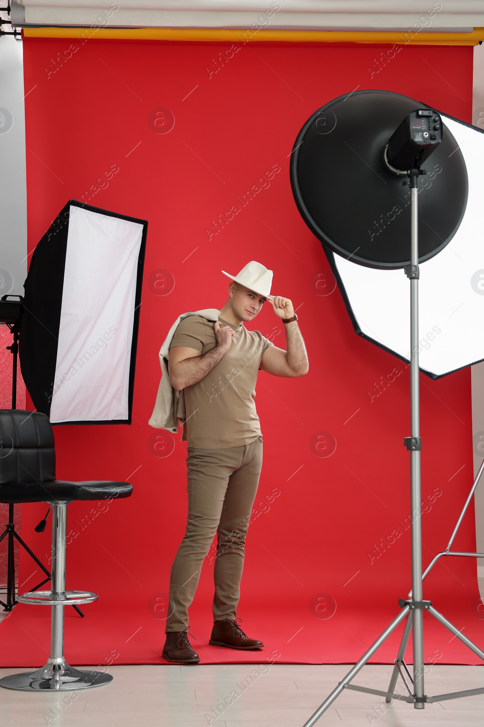 Photo of Handsome model posing in studio. Professional photo session