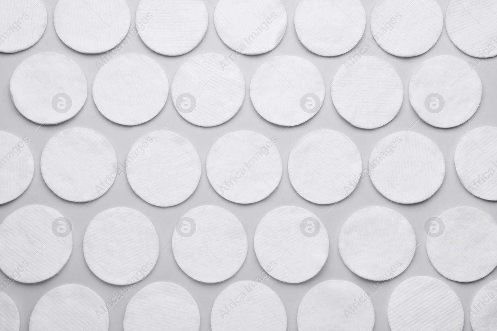 Photo of Many clean cotton pads on light grey background, flat lay