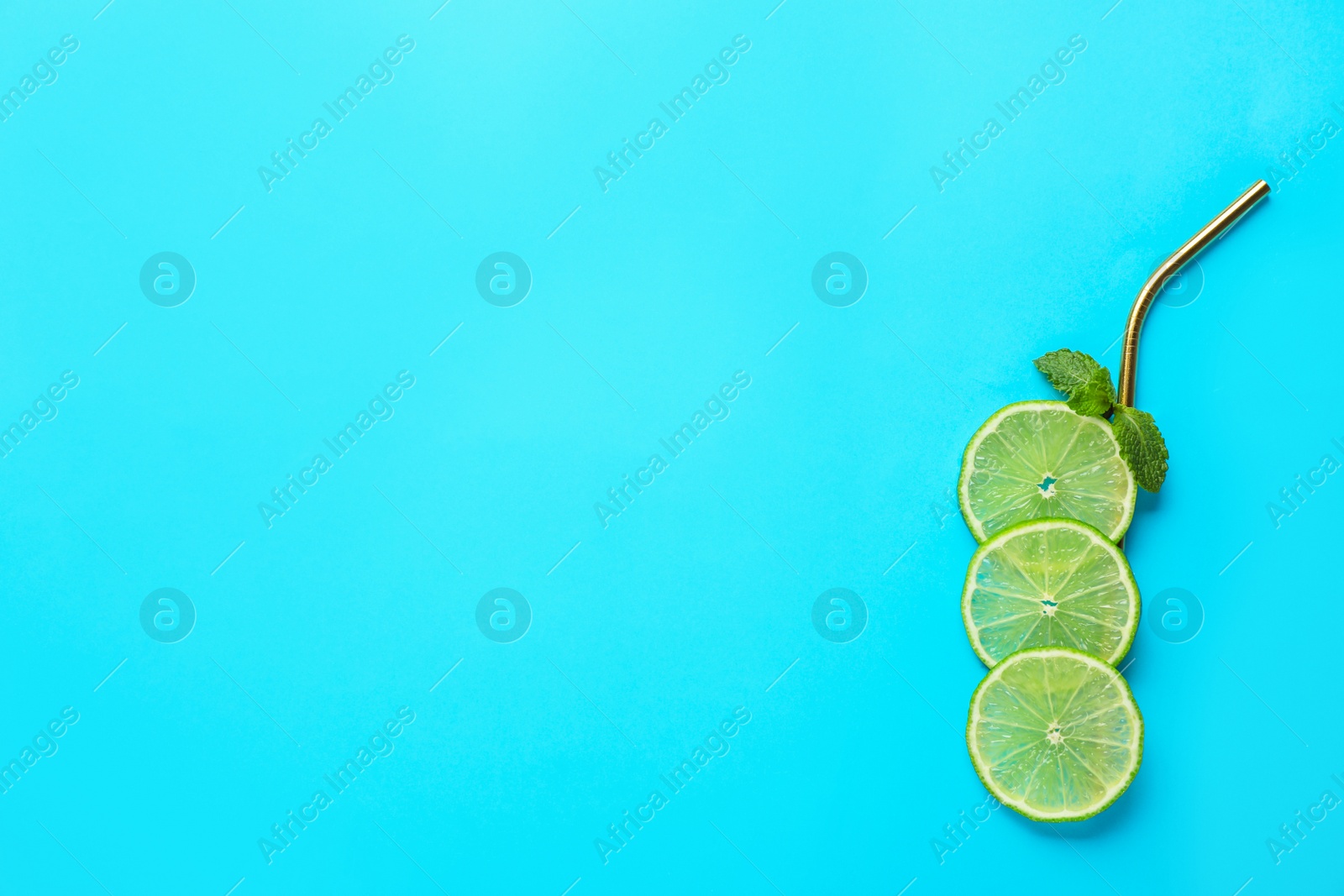 Photo of Creative image of summer cocktail made with lime slices, mint and straw on color background, top view. Space for text