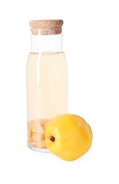 Photo of Tasty quince drink in glass carafe and fresh fruit isolated on white