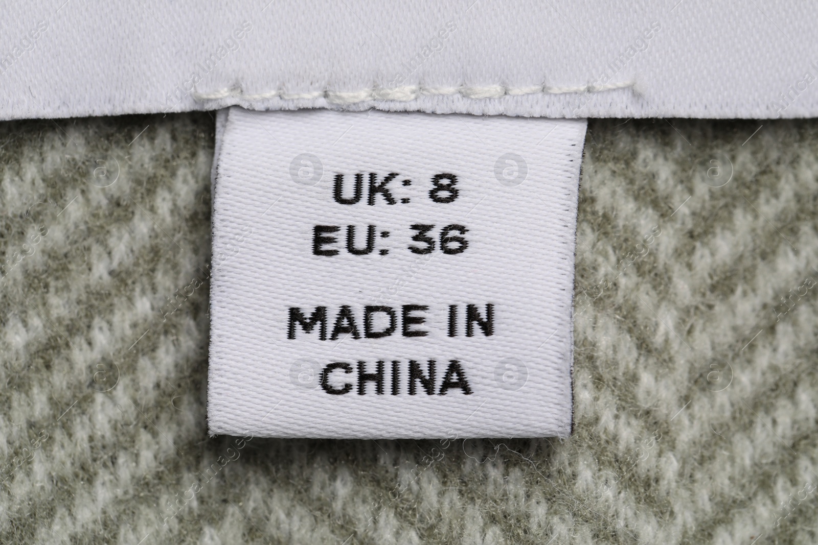 Photo of Clothing label on striped garment, top view