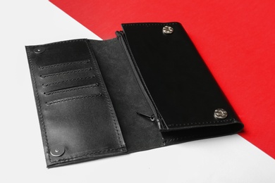 Photo of Black leather wallet on color background. Stylish accessory