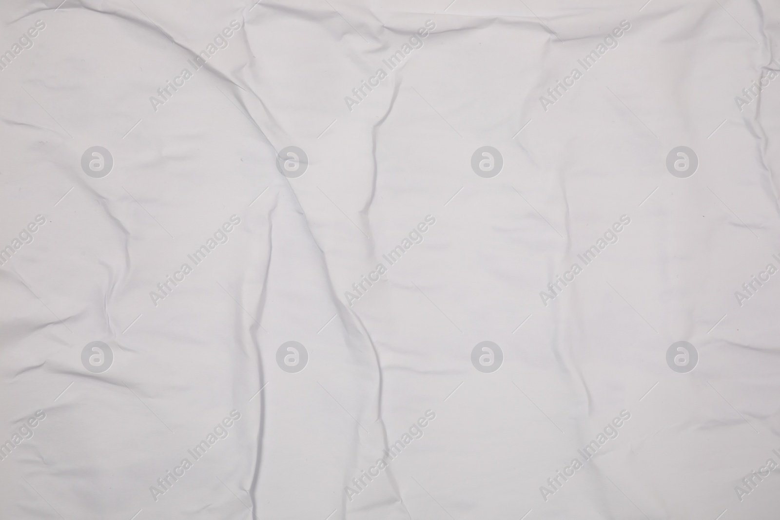 Photo of Top view of white creased blank poster as background, closeup