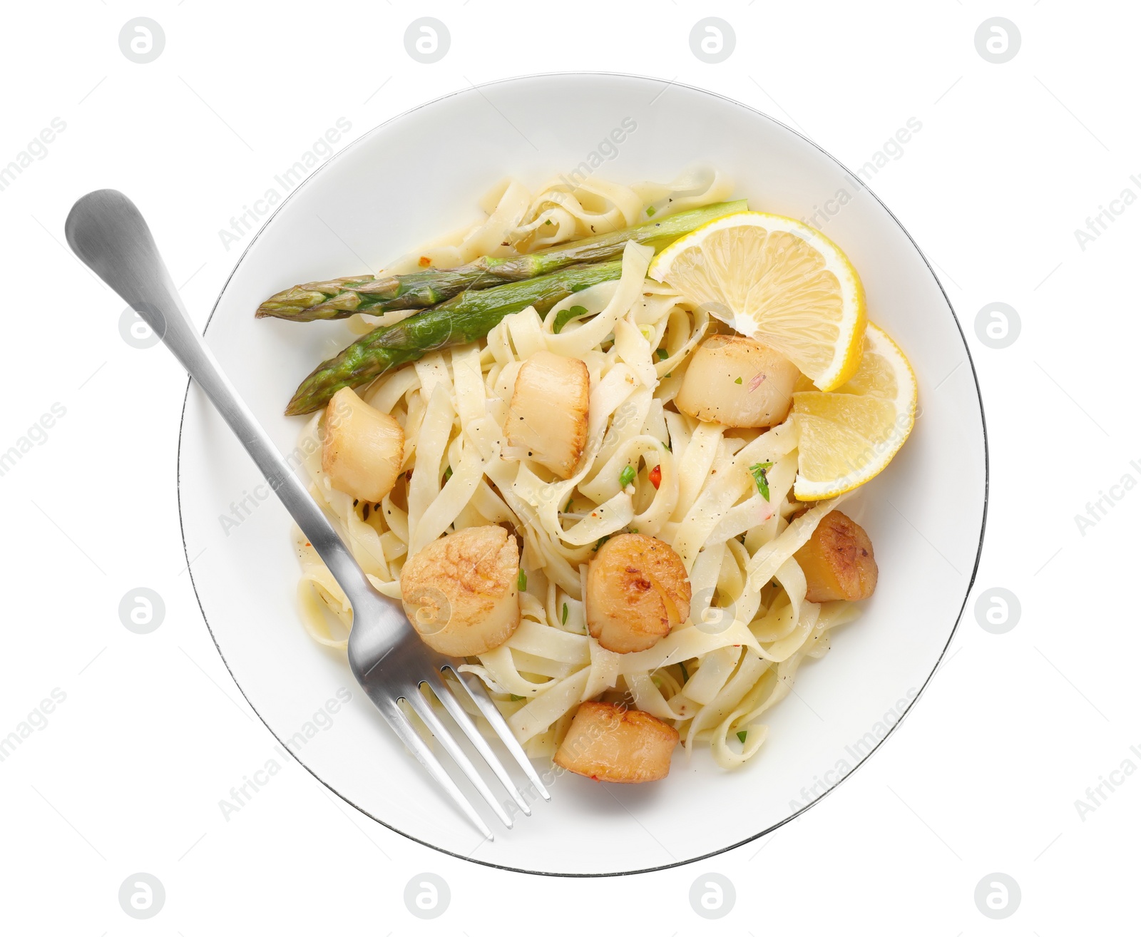 Photo of Delicious scallop pasta with asparagus, lemon and fork isolated on white, top view