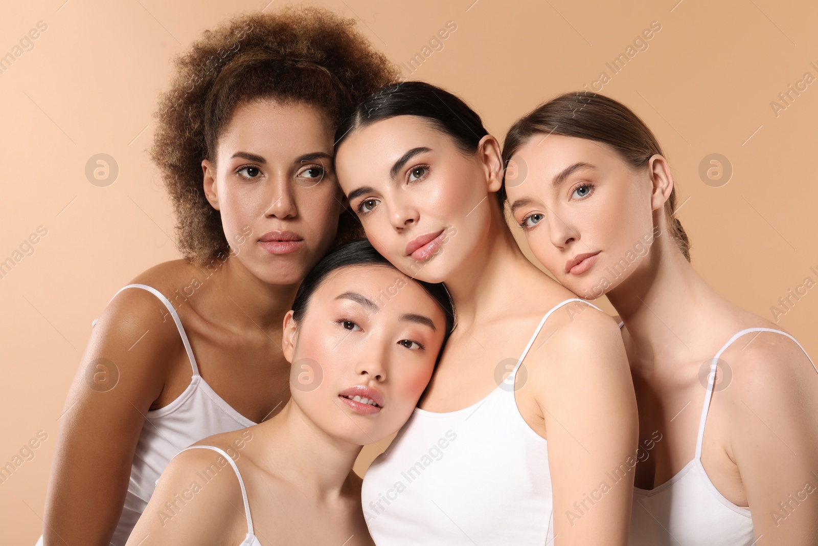 Photo of Beautiful young women with healthy skin on beige background