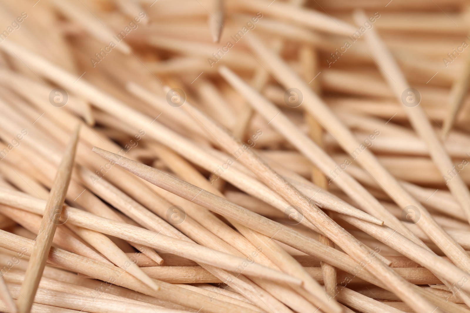 Photo of Disposable wooden toothpicks as background, closeup view
