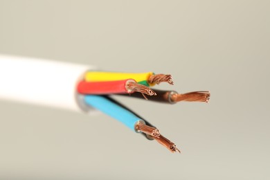 Photo of Electrical wires on light background, closeup view