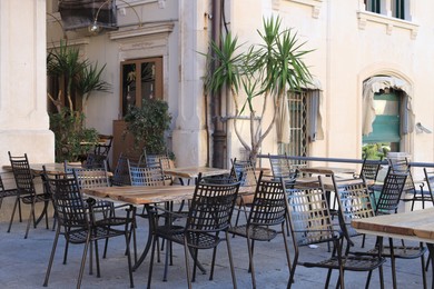 Photo of Outdoor cafe with stylish furniture and green plants