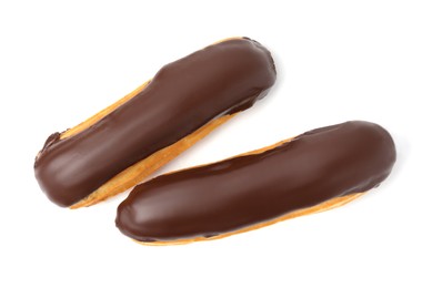 Delicious eclairs covered with chocolate isolated on white, top view