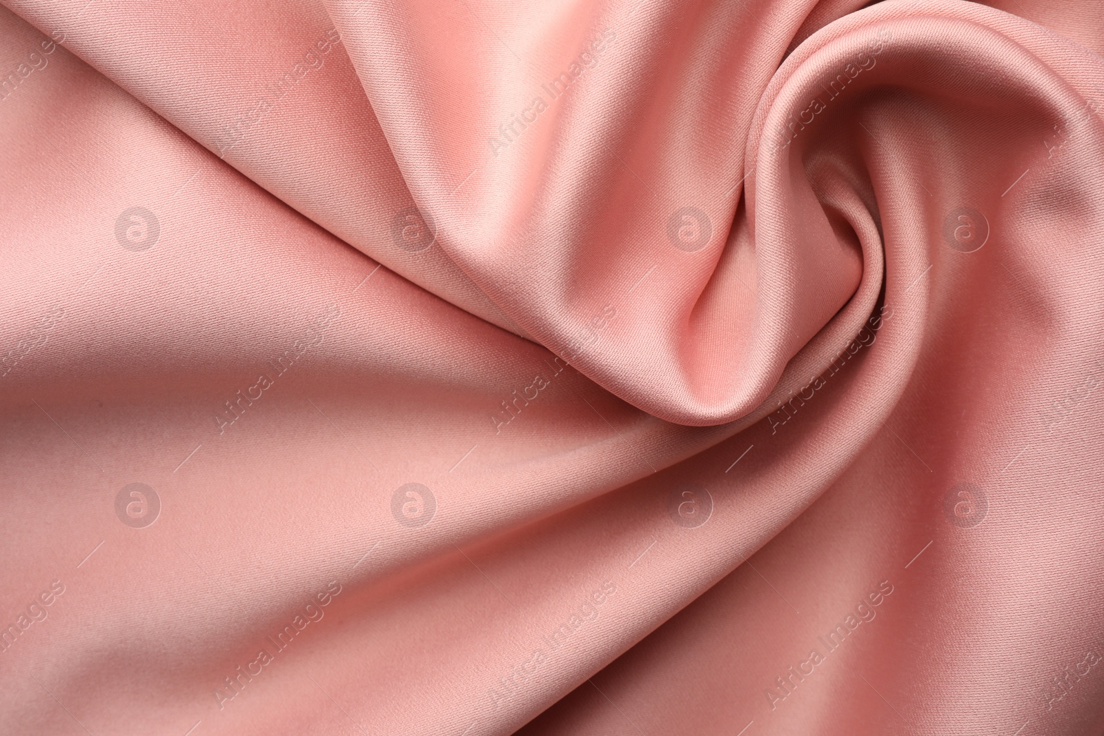 Photo of Crumpled pink silk fabric as background, top view