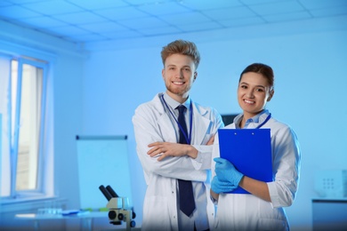 Portrait of scientists in chemistry laboratory, space for text