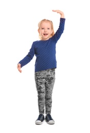 Little girl measuring her height on white background