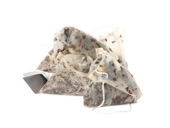 Photo of Used pyramid tea bags on white background