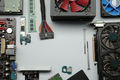 Photo of Frame of graphics card and other computer hardware on light background, flat lay. Space for text
