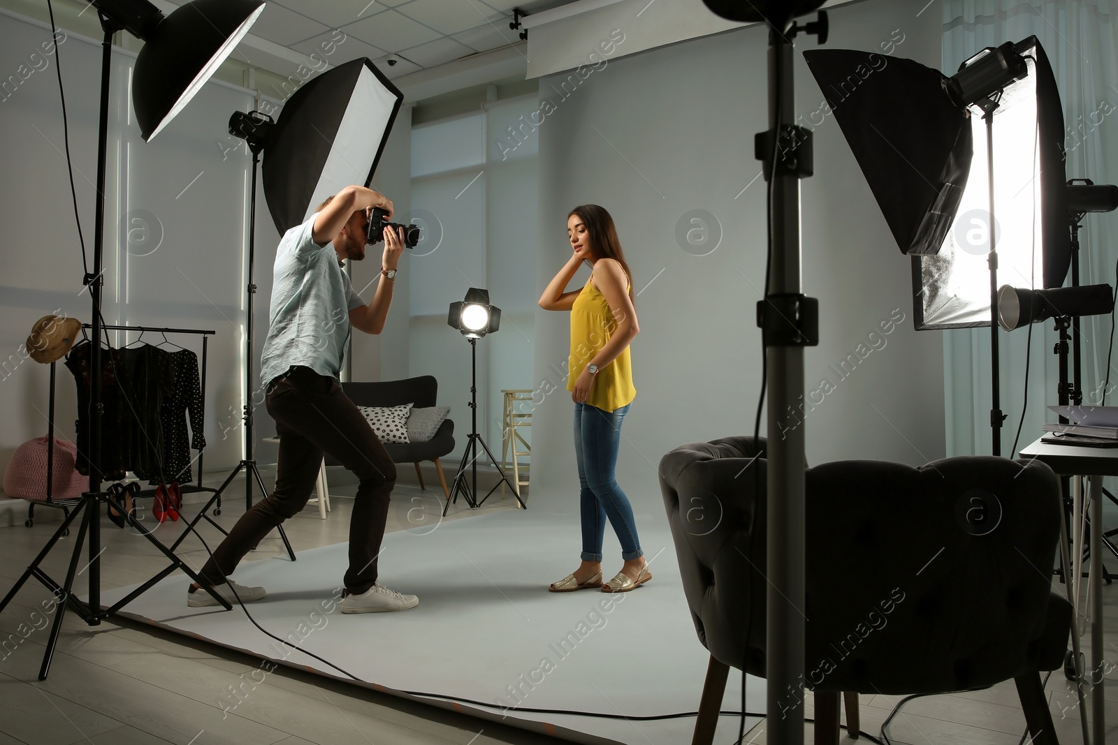 Photo of Beautiful model posing for professional photographer in studio