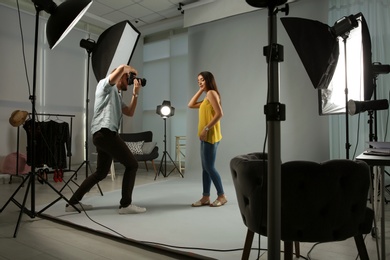 Photo of Beautiful model posing for professional photographer in studio