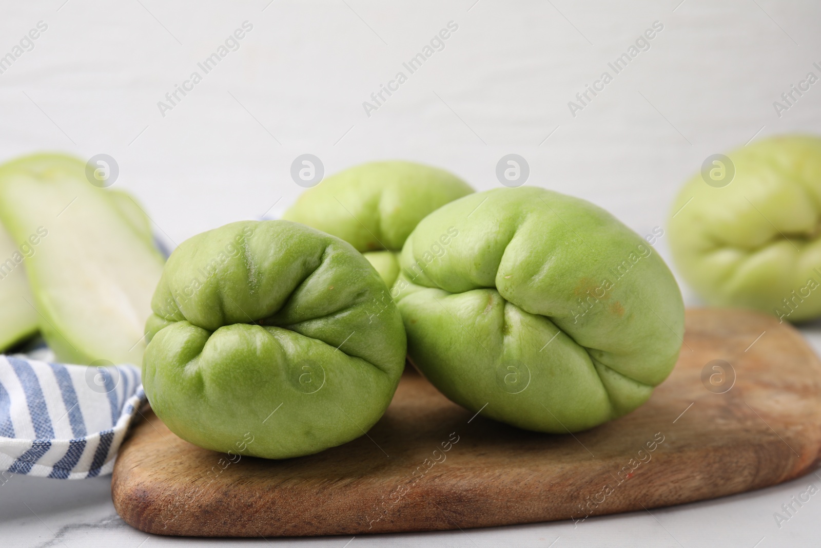 Photo of Fresh green chayote on light table, closeup