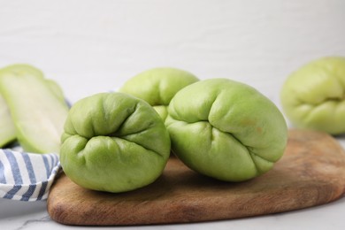 Fresh green chayote on light table, closeup