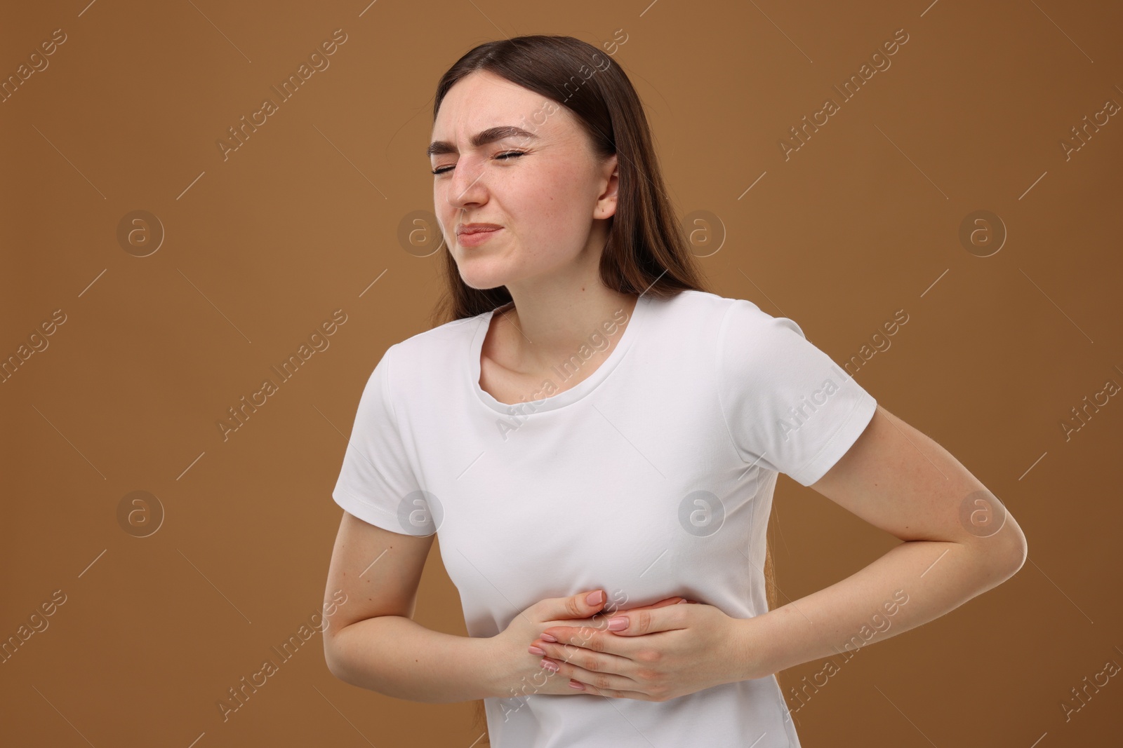 Photo of Woman having heart attack on brown background