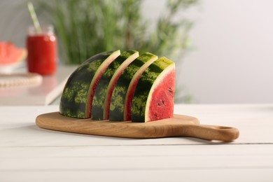 Photo of Slices of delicious ripe watermelon on white wooden table indoors