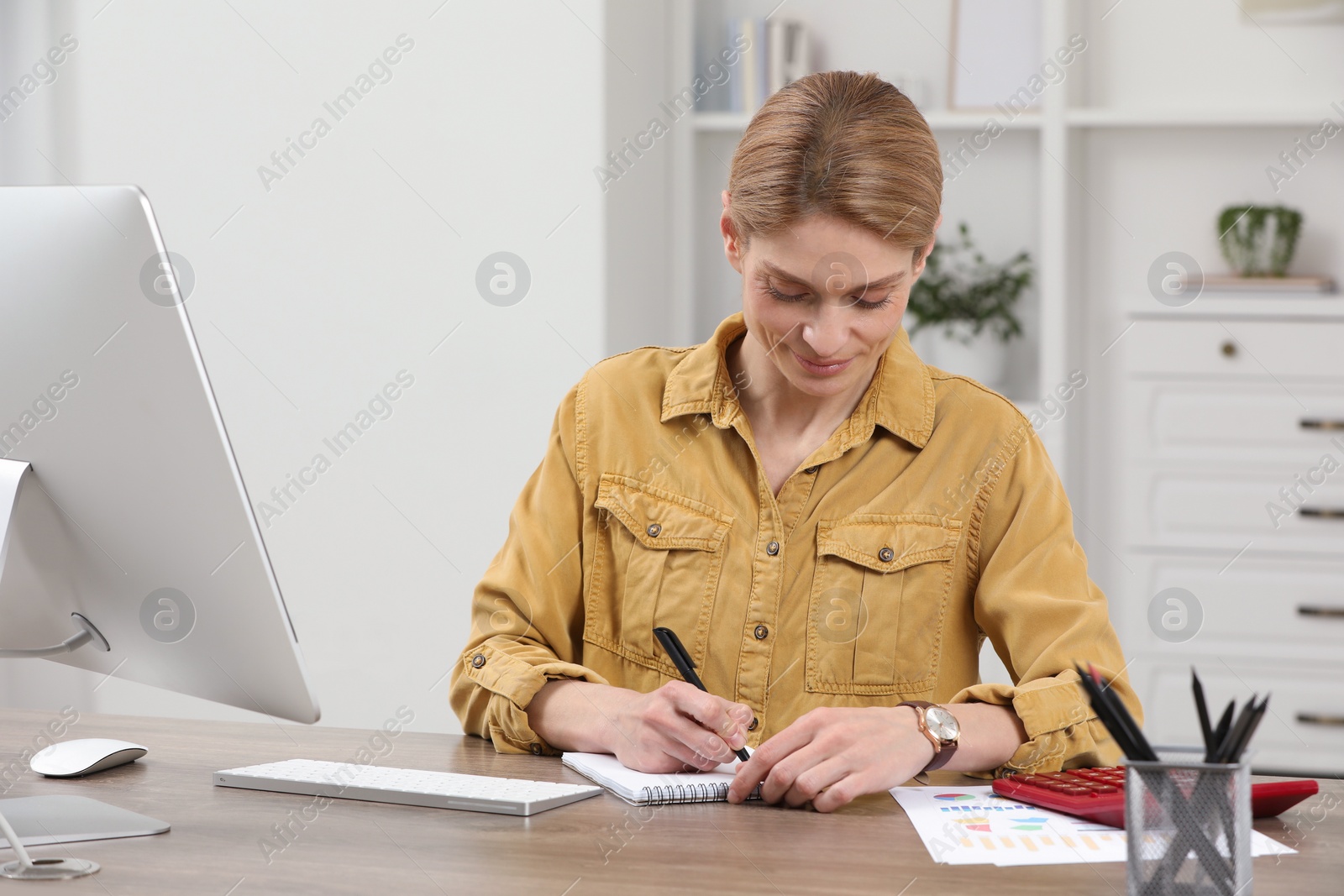 Photo of Professional accountant working at wooden desk in office