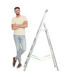 Young handsome man near metal ladder on white background