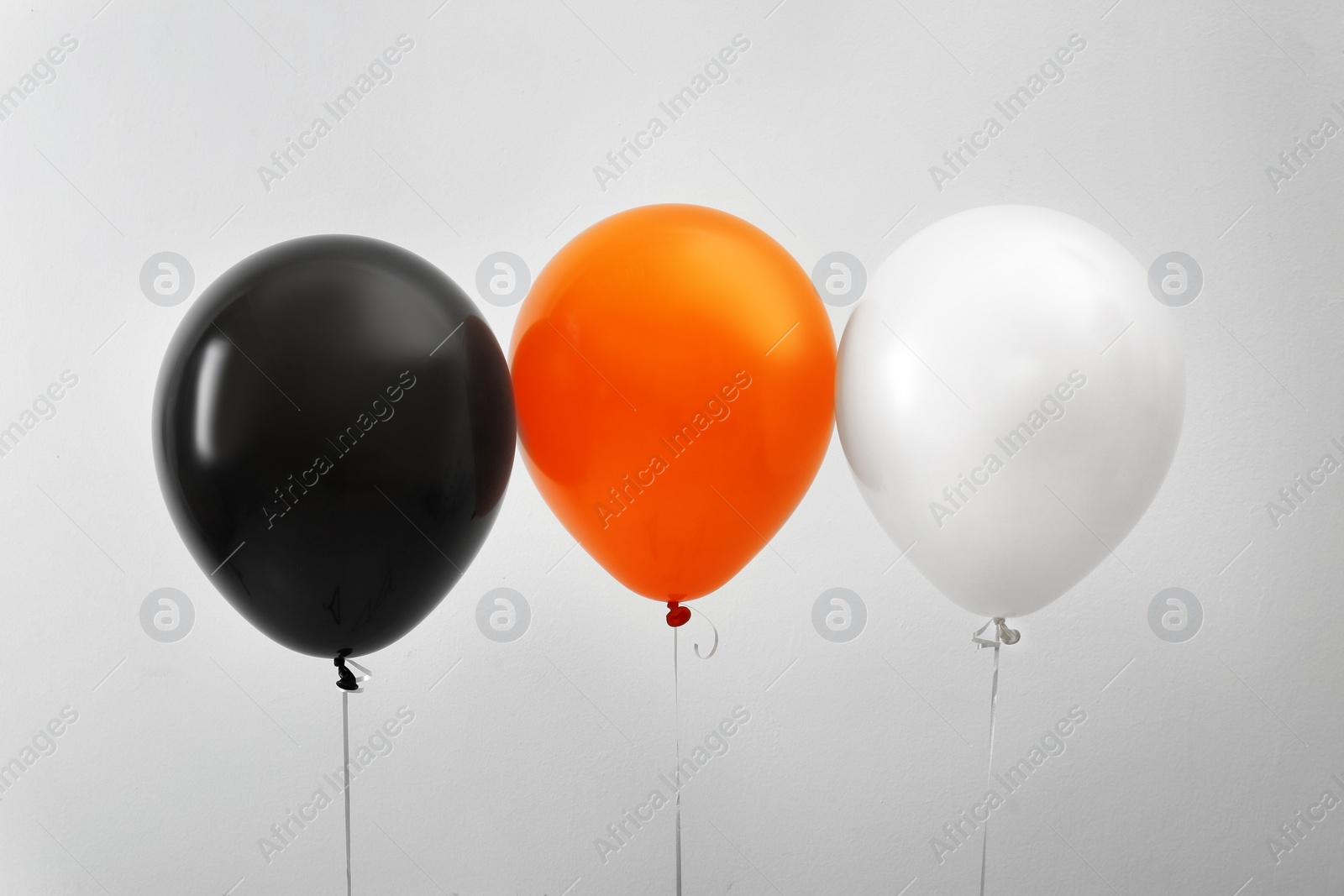 Photo of Colorful balloons on light background. Halloween party