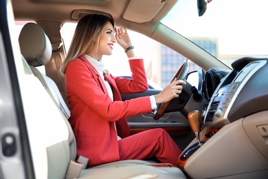 Young businesswoman on driver's seat of car