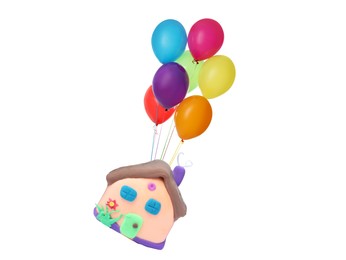 Many balloons tied to playdough house flying on white background