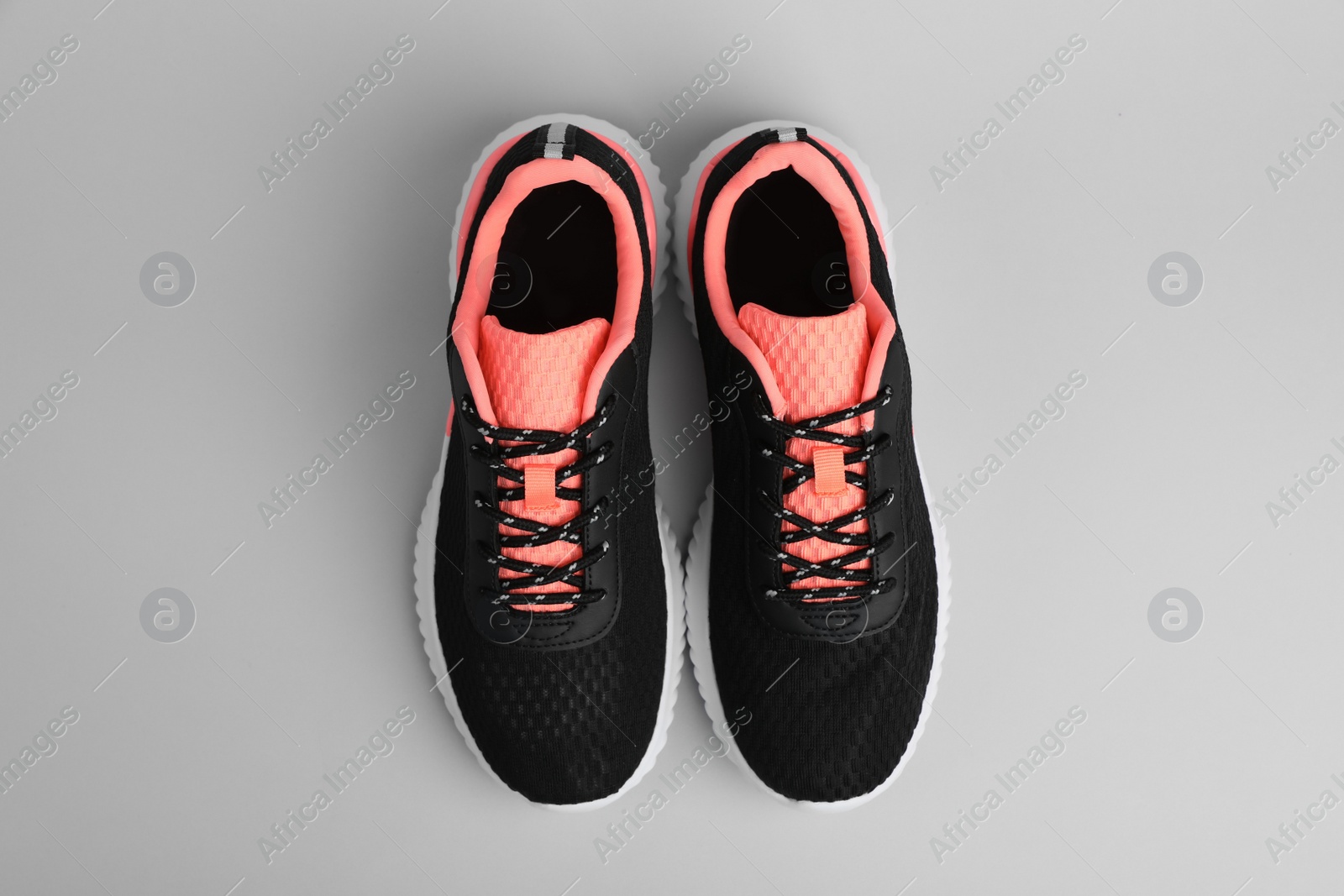 Photo of Pair of comfortable sports shoes on grey background, flat lay