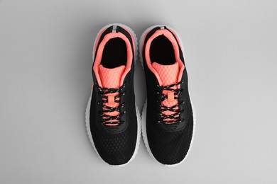 Pair of comfortable sports shoes on grey background, flat lay