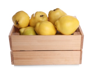 Photo of Ripe quinces in wooden crate on white background