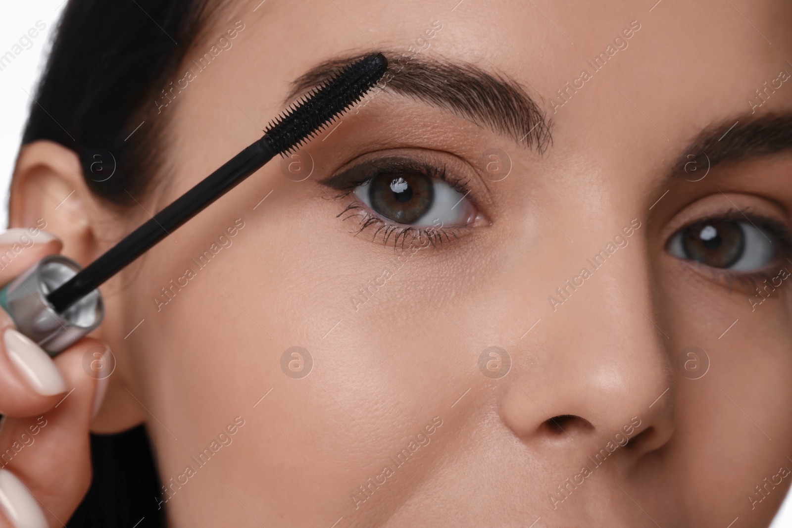 Photo of Beautiful young woman applying mascara, closeup view