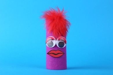 Photo of Purple monster on light blue background. Halloween decoration