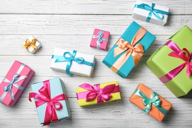 Photo of Flat lay composition with beautiful gift boxes on wooden background