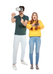 Man wearing VR headset and woman with controller playing video games isolated on white