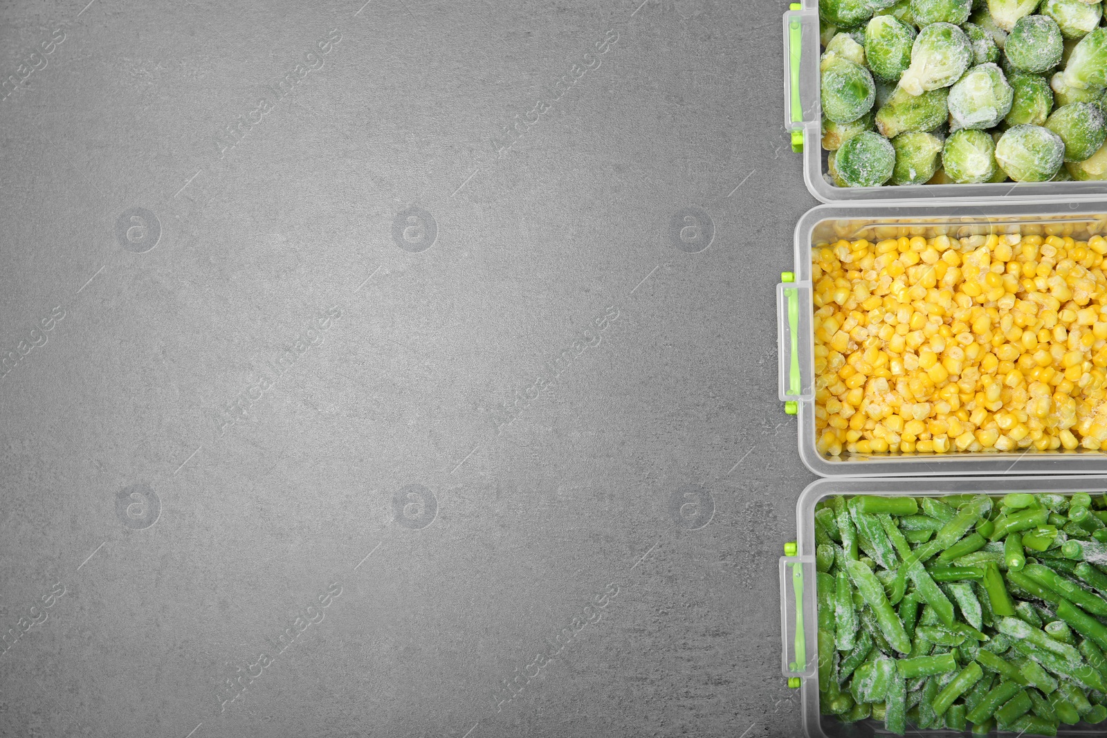 Photo of Plastic containers with frozen vegetables on grey background, top view