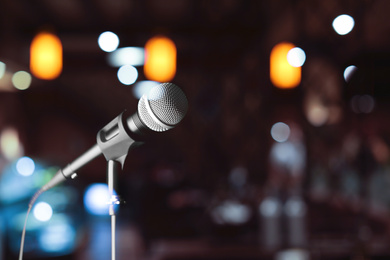 Image of Modern microphone in karaoke club. Space for text